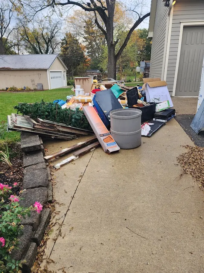 Dumpster being loaded with debris for 12 Yard Dumpster Rental in Dowagiac